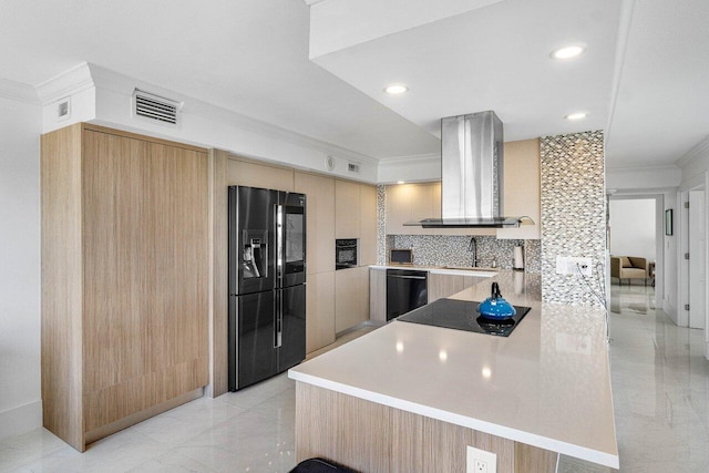 kitchen featuring backsplash, island range hood, kitchen peninsula, black appliances, and ornamental molding