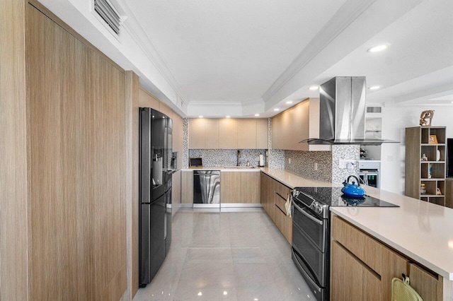 kitchen with black appliances, island range hood, ornamental molding, and decorative backsplash