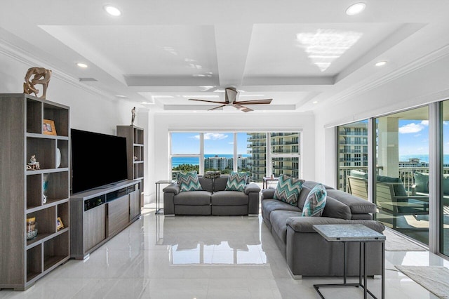 living room featuring ornamental molding, a tray ceiling, and ceiling fan