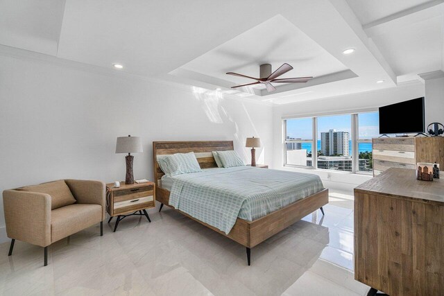 bedroom with a raised ceiling, ornamental molding, and ceiling fan