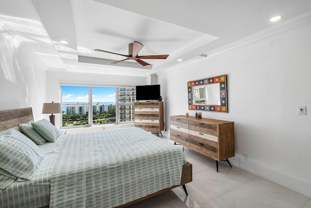 bedroom featuring ornamental molding, a tray ceiling, and ceiling fan