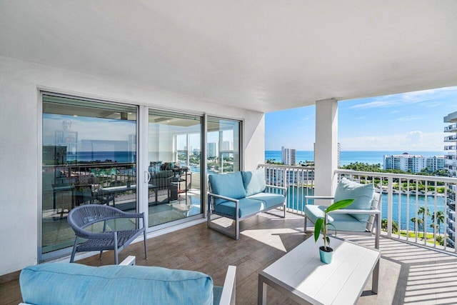 balcony with an outdoor hangout area and a water view