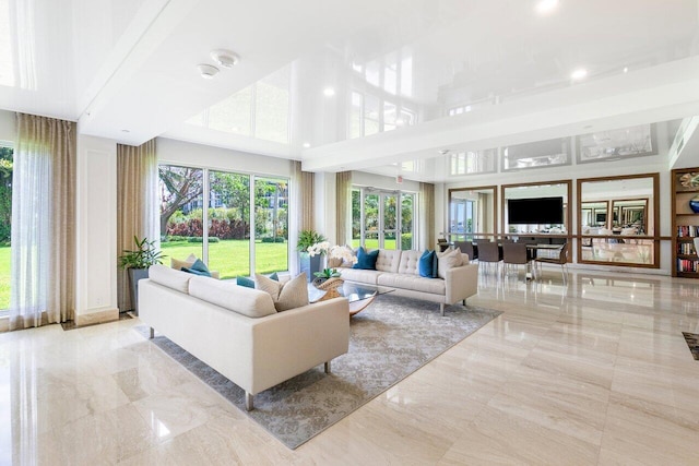 living room featuring a towering ceiling