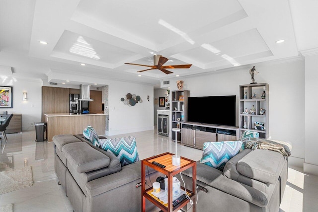 living room featuring ceiling fan, beam ceiling, ornamental molding, and coffered ceiling