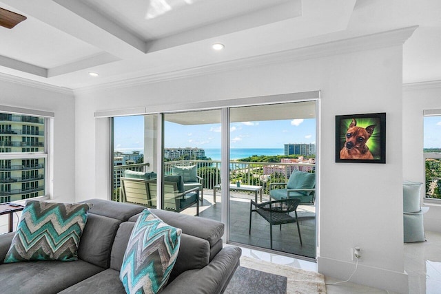 tiled living room with ornamental molding and a water view