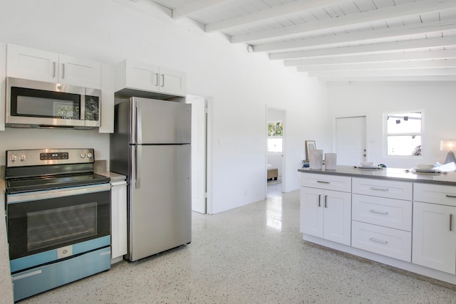 kitchen featuring white cabinetry, lofted ceiling with beams, stainless steel appliances, and wooden ceiling