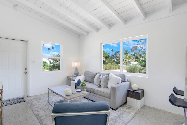 living room with a wealth of natural light, vaulted ceiling with beams, and wooden ceiling