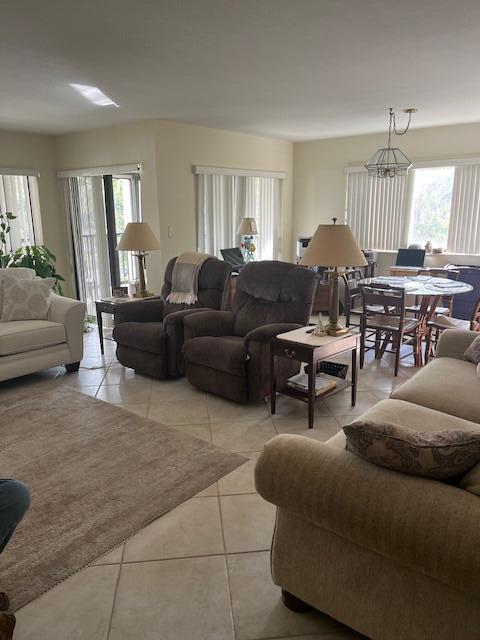 living room featuring a wealth of natural light and light tile patterned flooring