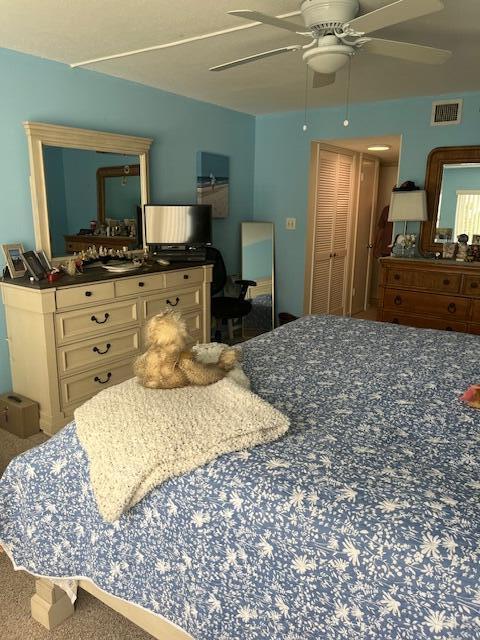 bedroom with visible vents and a ceiling fan