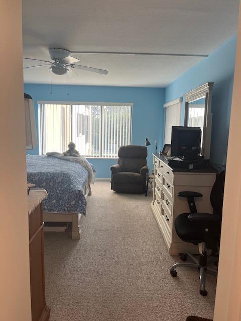 carpeted bedroom with a ceiling fan