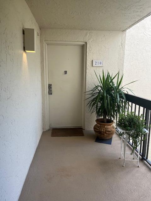 entrance to property featuring a balcony