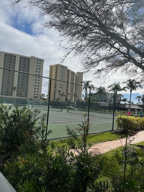 view of tennis court featuring fence