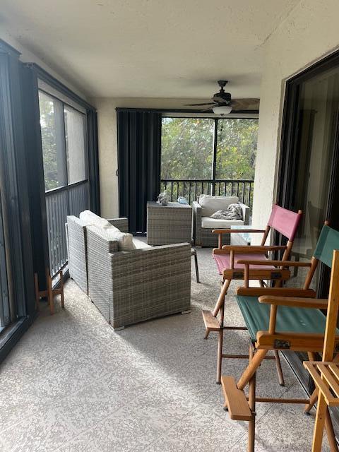 sunroom featuring ceiling fan and a healthy amount of sunlight