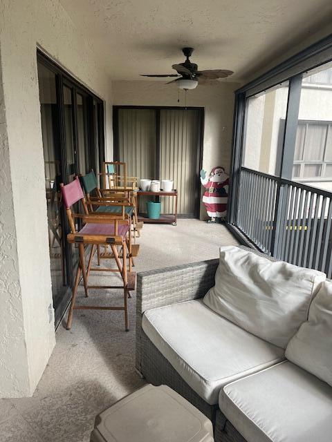 sunroom / solarium featuring ceiling fan