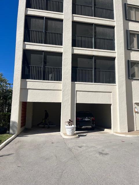 view of building exterior featuring a garage and driveway