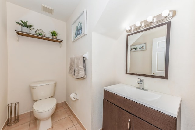 bathroom with tile patterned flooring, vanity, and toilet