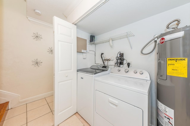 laundry room with electric water heater, washer and clothes dryer, light tile patterned flooring, and crown molding