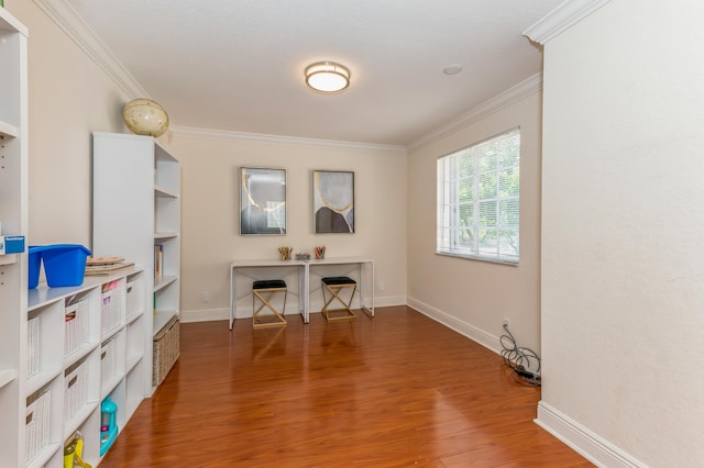 office area with hardwood / wood-style flooring and crown molding