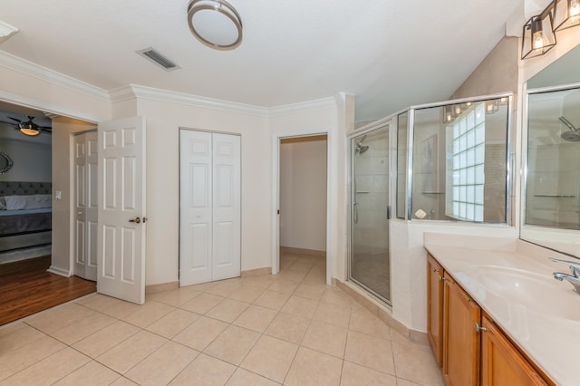 bathroom with tile patterned flooring, vanity, an enclosed shower, and ornamental molding