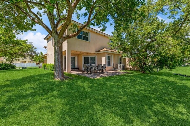 rear view of property with a lawn and a patio area