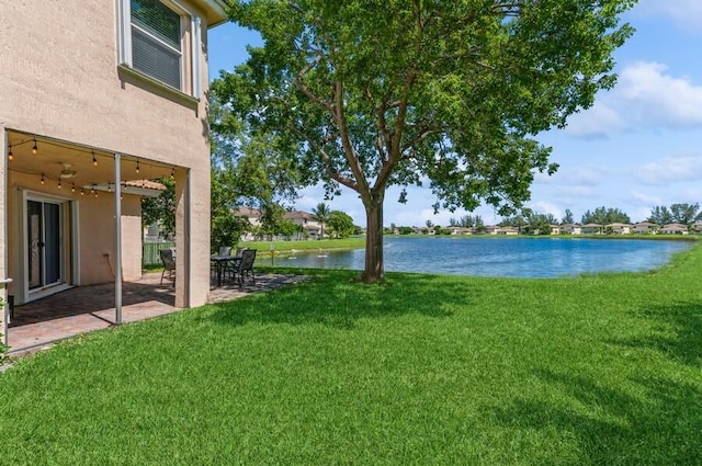 view of yard featuring a water view and a patio area