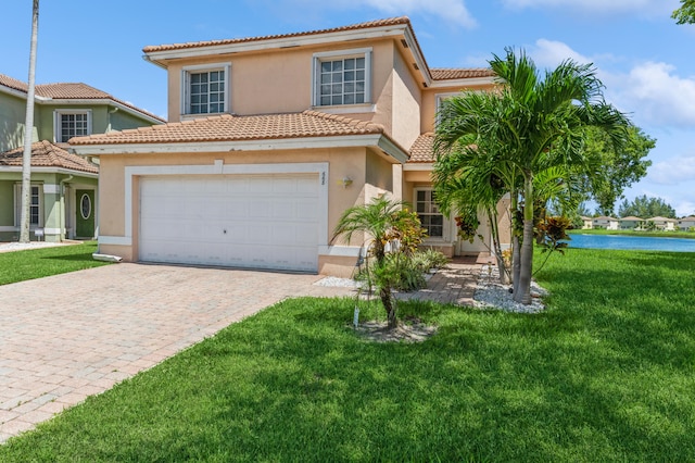 mediterranean / spanish house with a front lawn and a garage