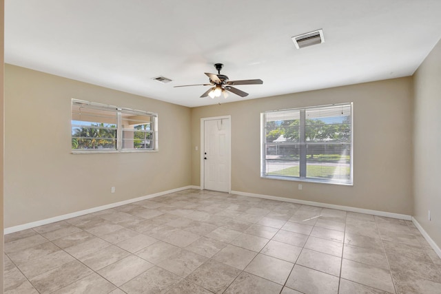 tiled empty room with ceiling fan