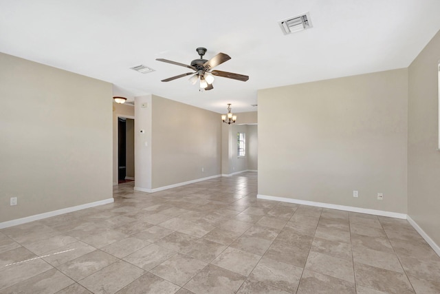 unfurnished room featuring ceiling fan with notable chandelier