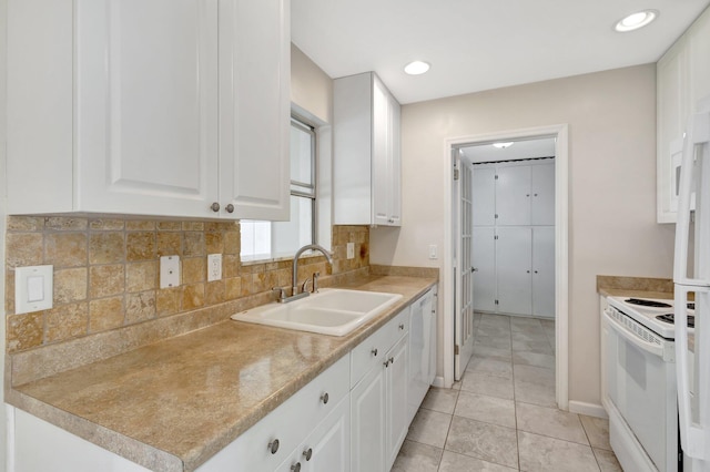 kitchen with white appliances, backsplash, sink, white cabinetry, and light tile patterned flooring