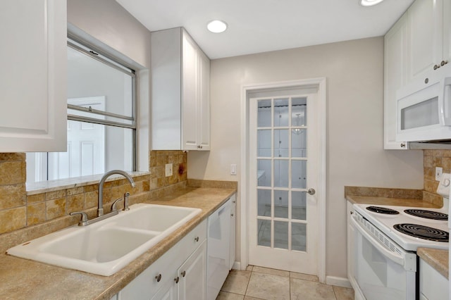 kitchen featuring white appliances, tasteful backsplash, white cabinetry, and sink