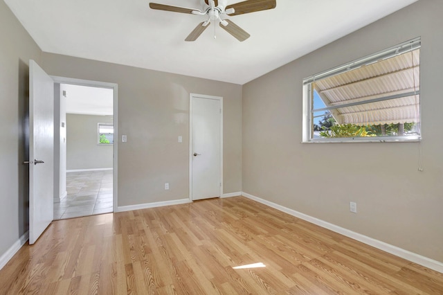 unfurnished bedroom with ceiling fan and light hardwood / wood-style flooring