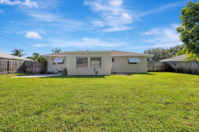 rear view of house with a lawn