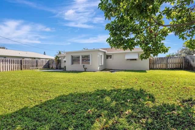 back of house featuring a yard