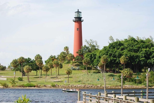 view of home's community featuring a water view and a lawn