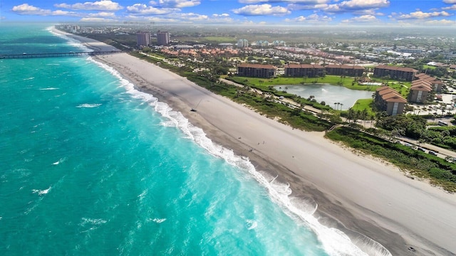 bird's eye view featuring a water view and a view of the beach