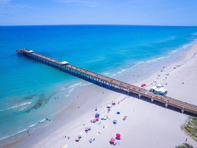 drone / aerial view with a water view and a view of the beach