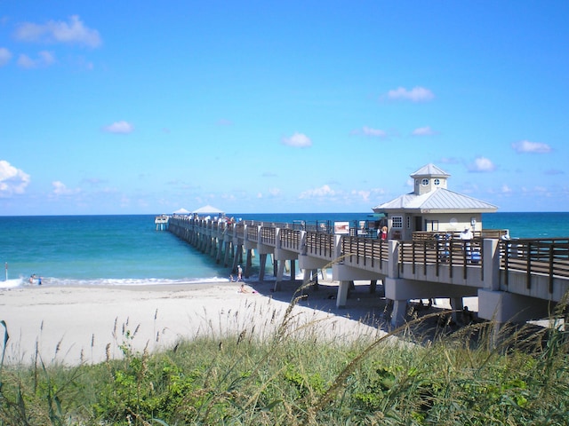 dock area with a beach view and a water view