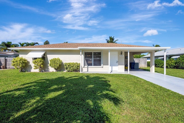 ranch-style house with a carport and a front lawn