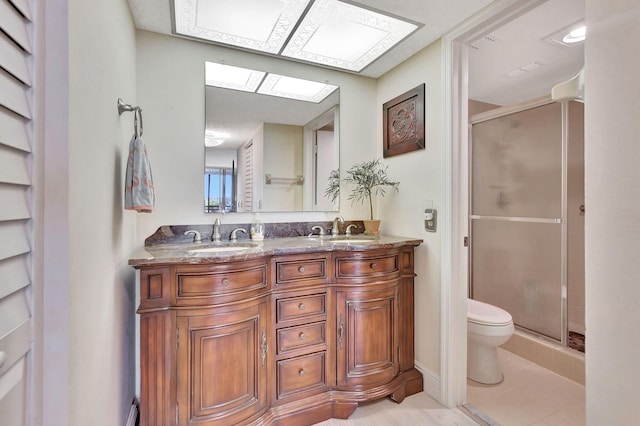 bathroom featuring walk in shower, a skylight, vanity, and toilet