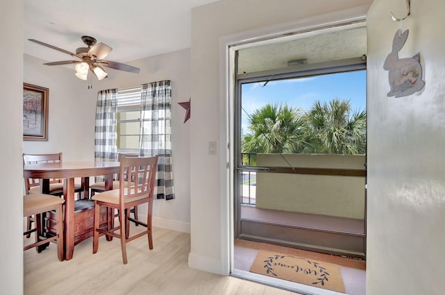 dining room with light hardwood / wood-style flooring, ceiling fan, and plenty of natural light