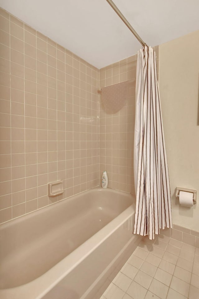 bathroom featuring tile patterned flooring and shower / tub combo with curtain