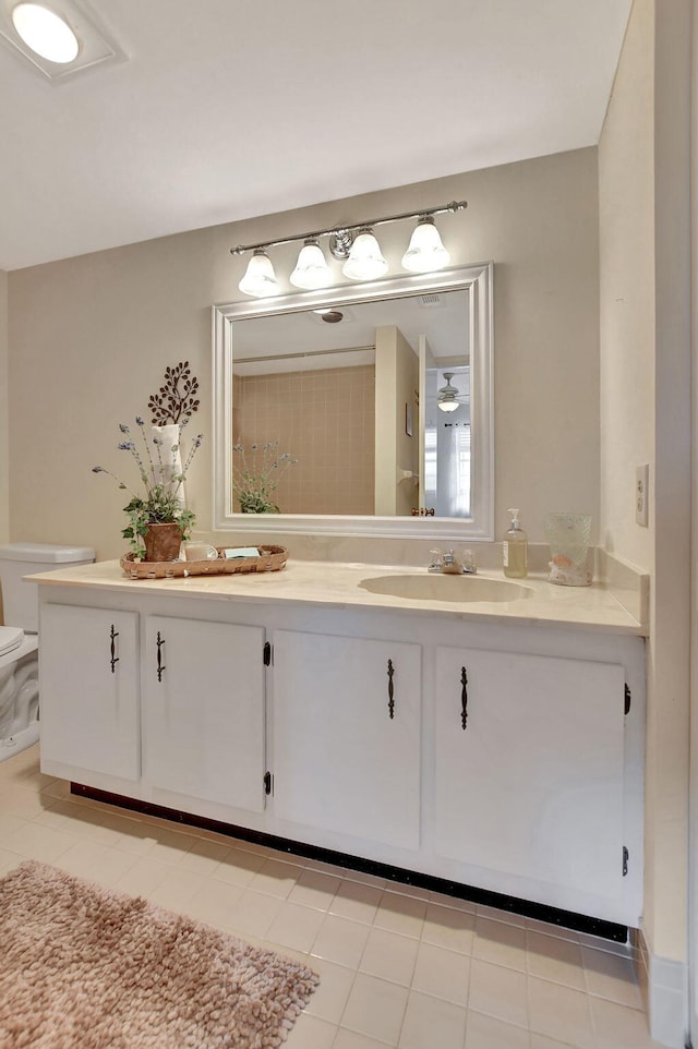 bathroom with vanity, toilet, and tile patterned floors