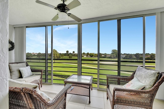 sunroom featuring ceiling fan and a healthy amount of sunlight