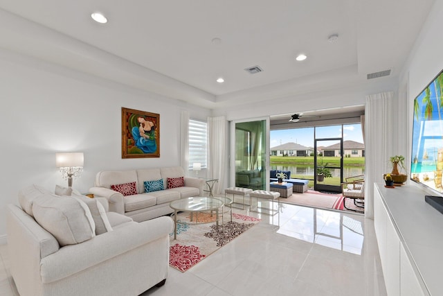 tiled living room with ceiling fan