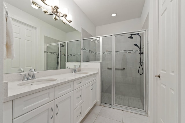 bathroom featuring vanity, tile patterned floors, and a shower with door