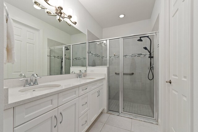 bathroom featuring tile patterned floors, vanity, and a shower with shower door