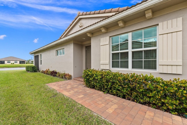 entrance to property featuring a yard