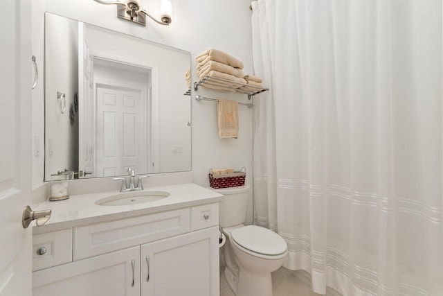 bathroom featuring tile patterned flooring, vanity, and toilet