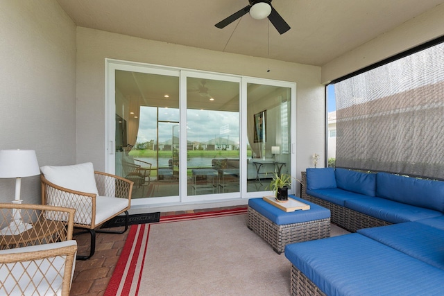 view of patio / terrace featuring an outdoor hangout area, a water view, and ceiling fan