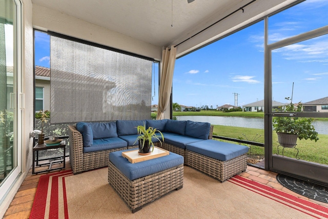 sunroom / solarium featuring a water view